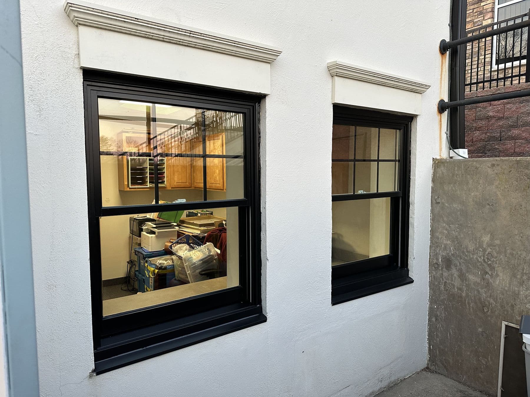 New black window units in the white wall of a commercial building