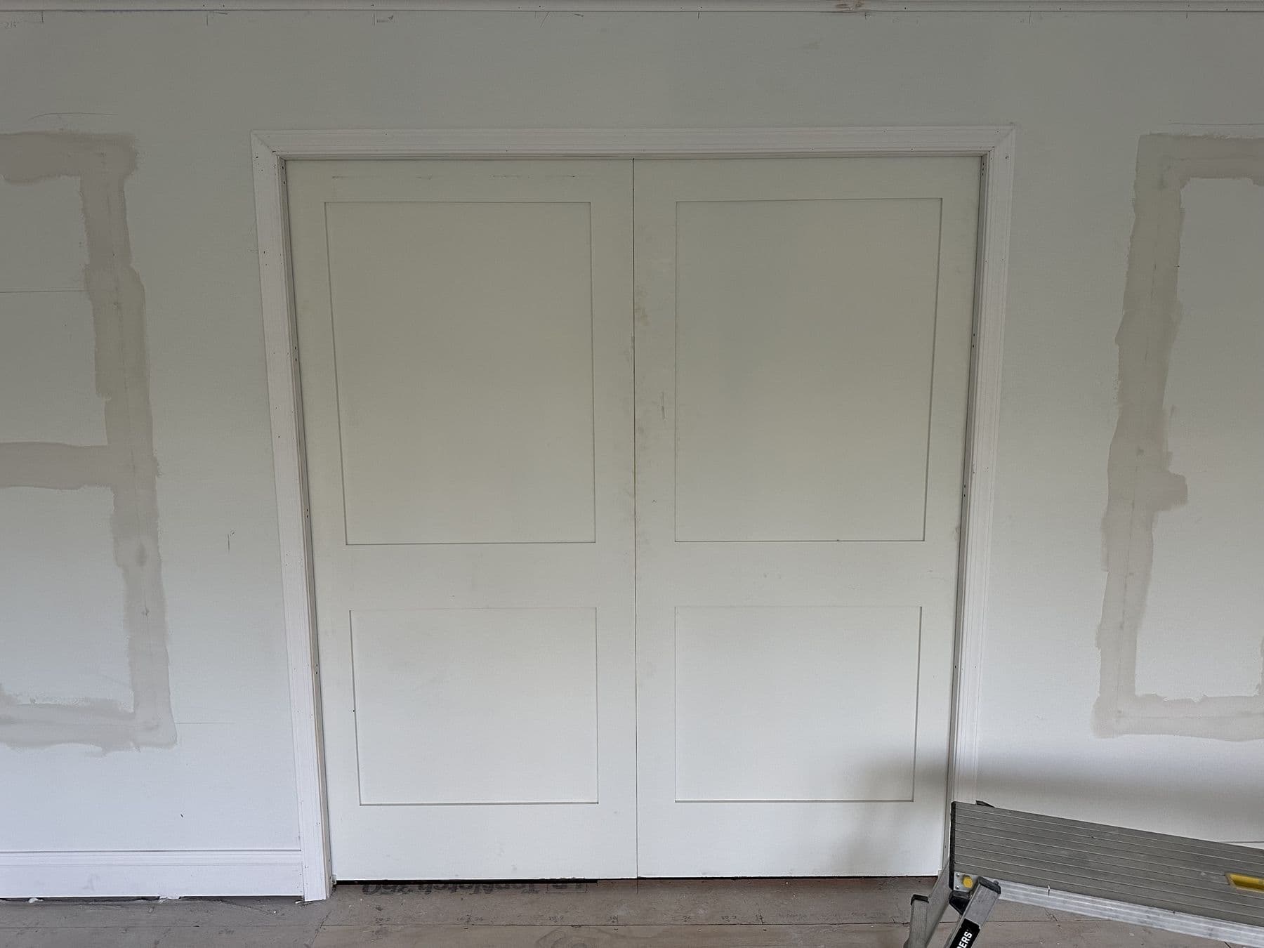 New double closet doors with casing, patching around the trim