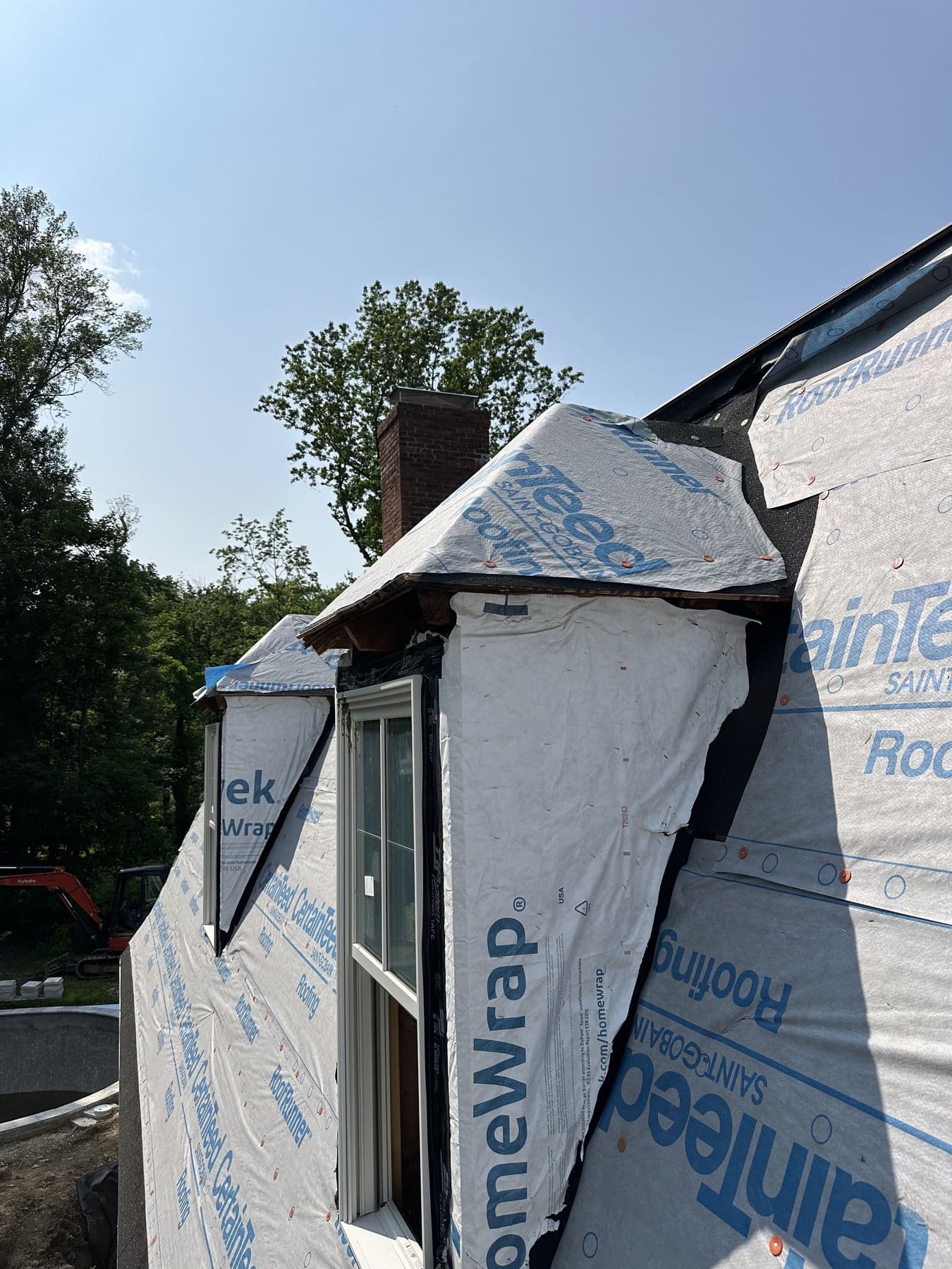New shed dormer cheek walls wrapped in housewrap and roof underlayment on the gambrel roof