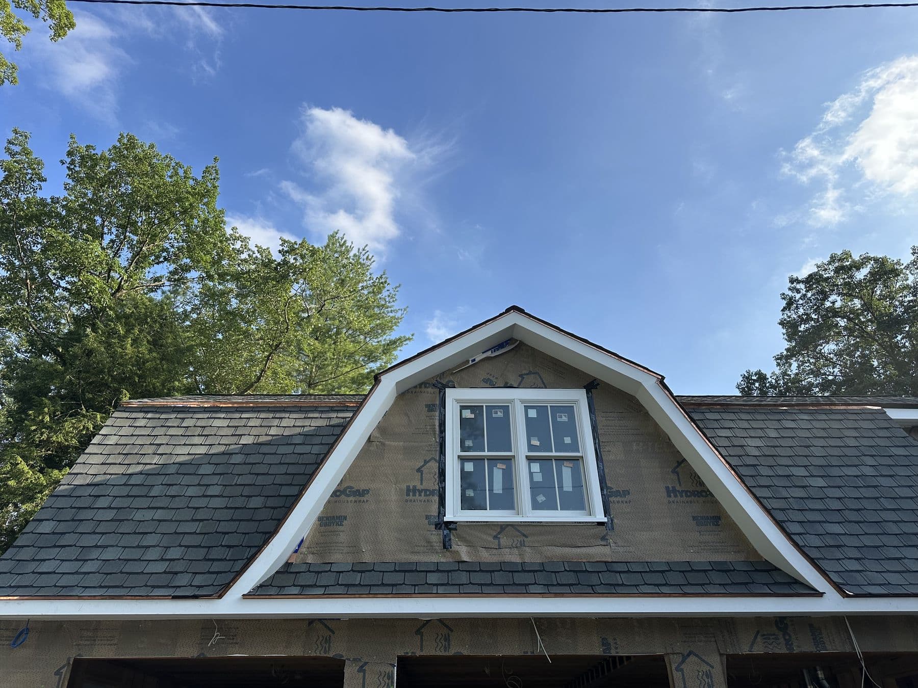 Single gambrel dormer above the garage roof with white trim