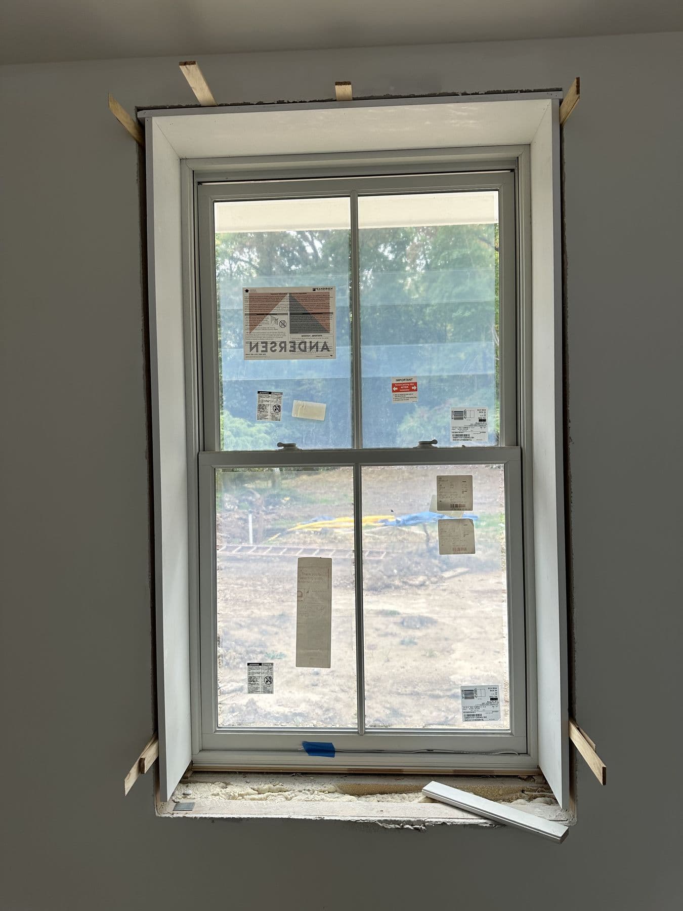 Double-hung window trimmed out next to a doorway