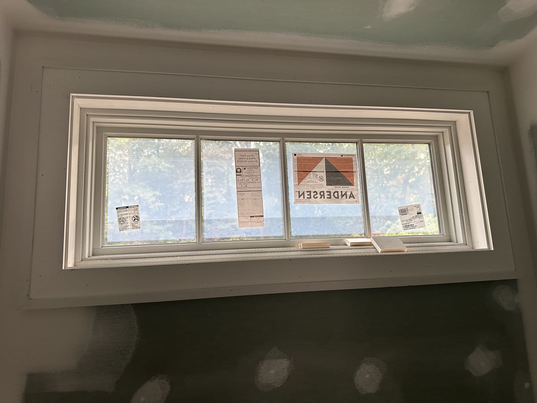 Wide Andersen picture window with a new jamb extension and casing