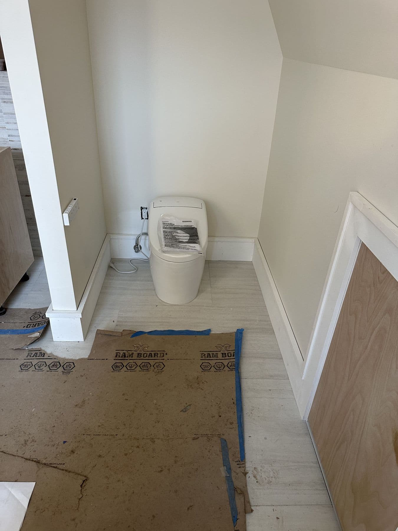 Bathroom corner with new baseboard and a trimmed knee wall