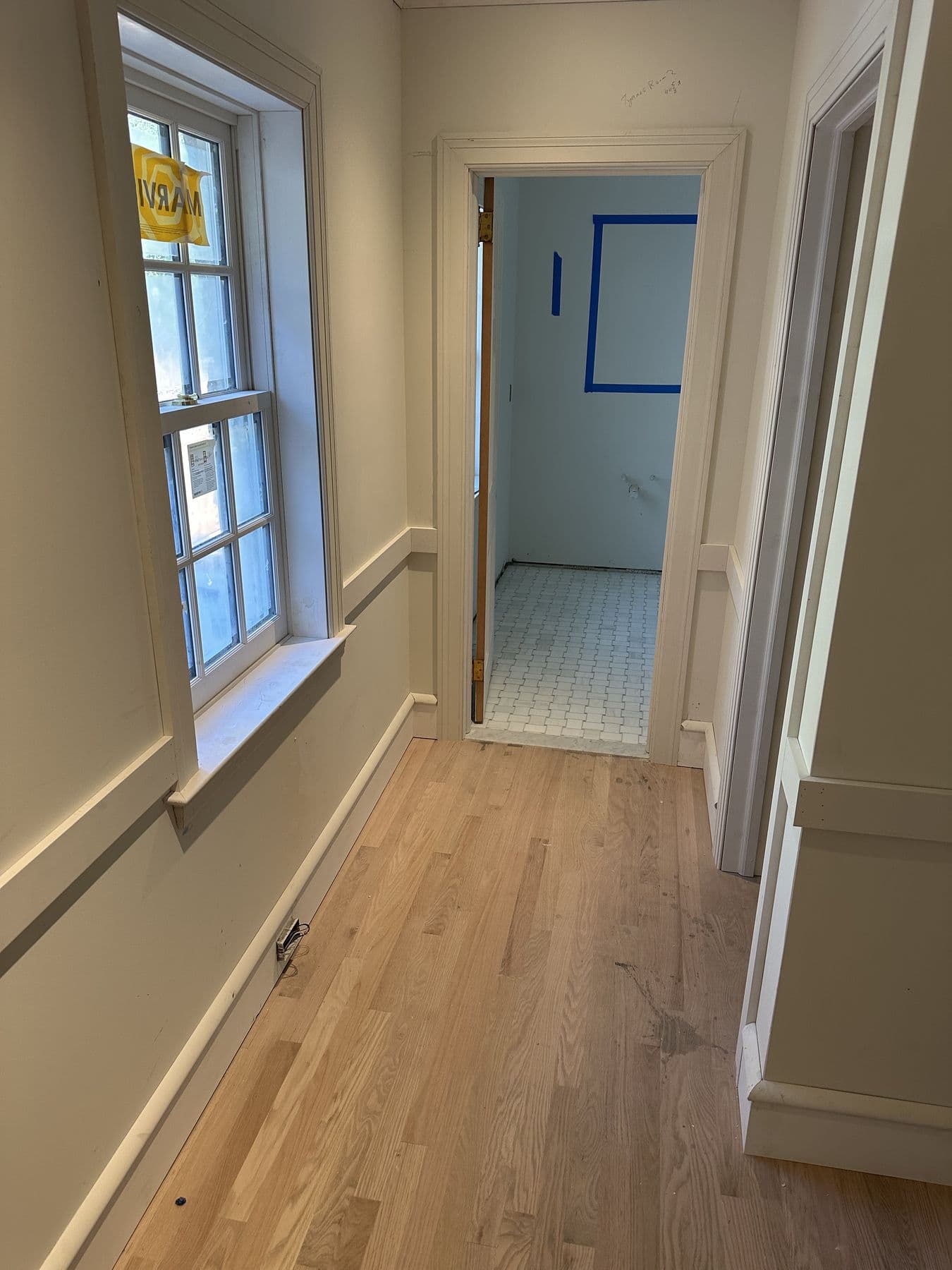 Upstairs hallway with new oak floor, window trim and wainscot