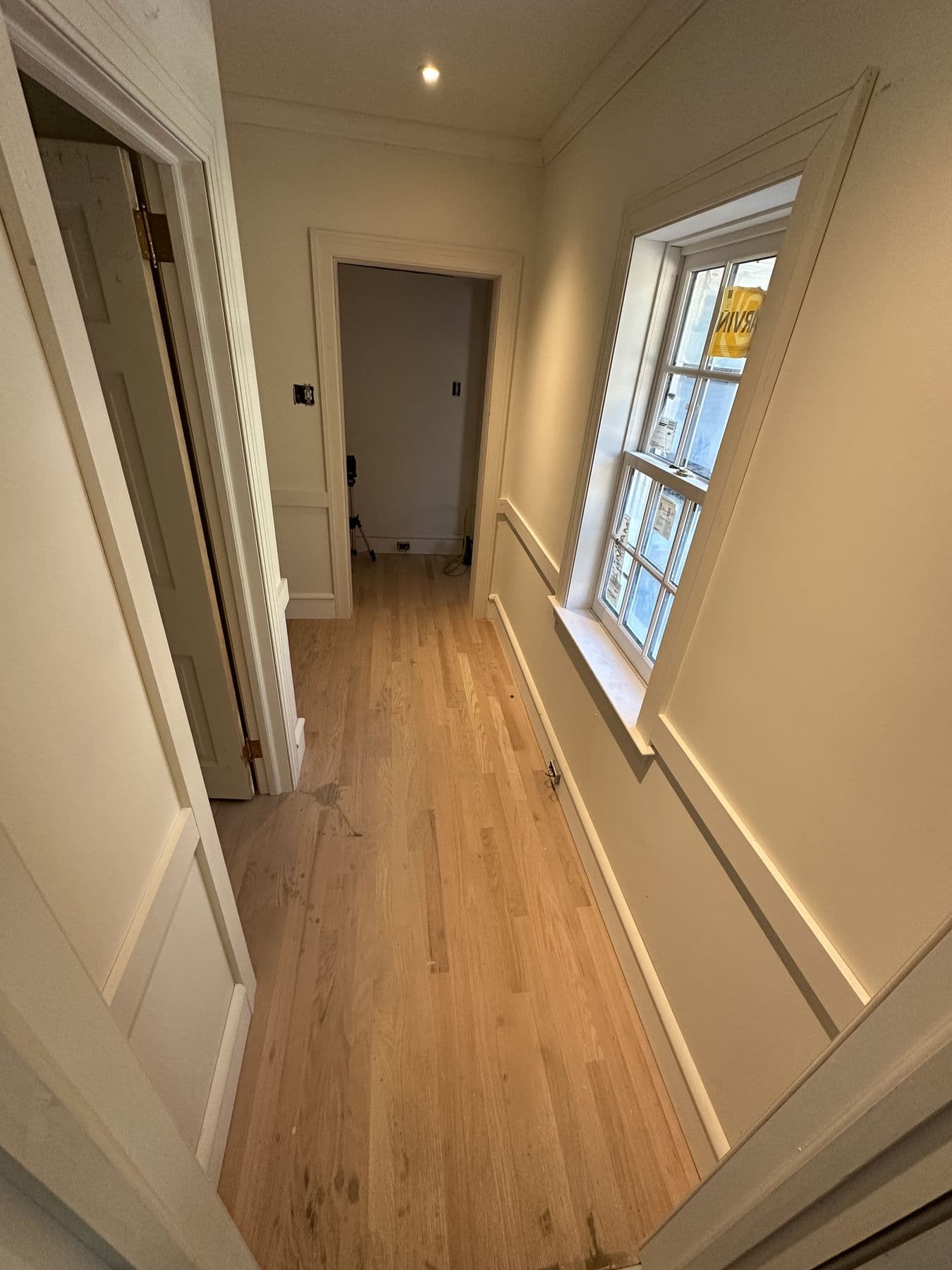 Hallway with new doors and casing leading to a window