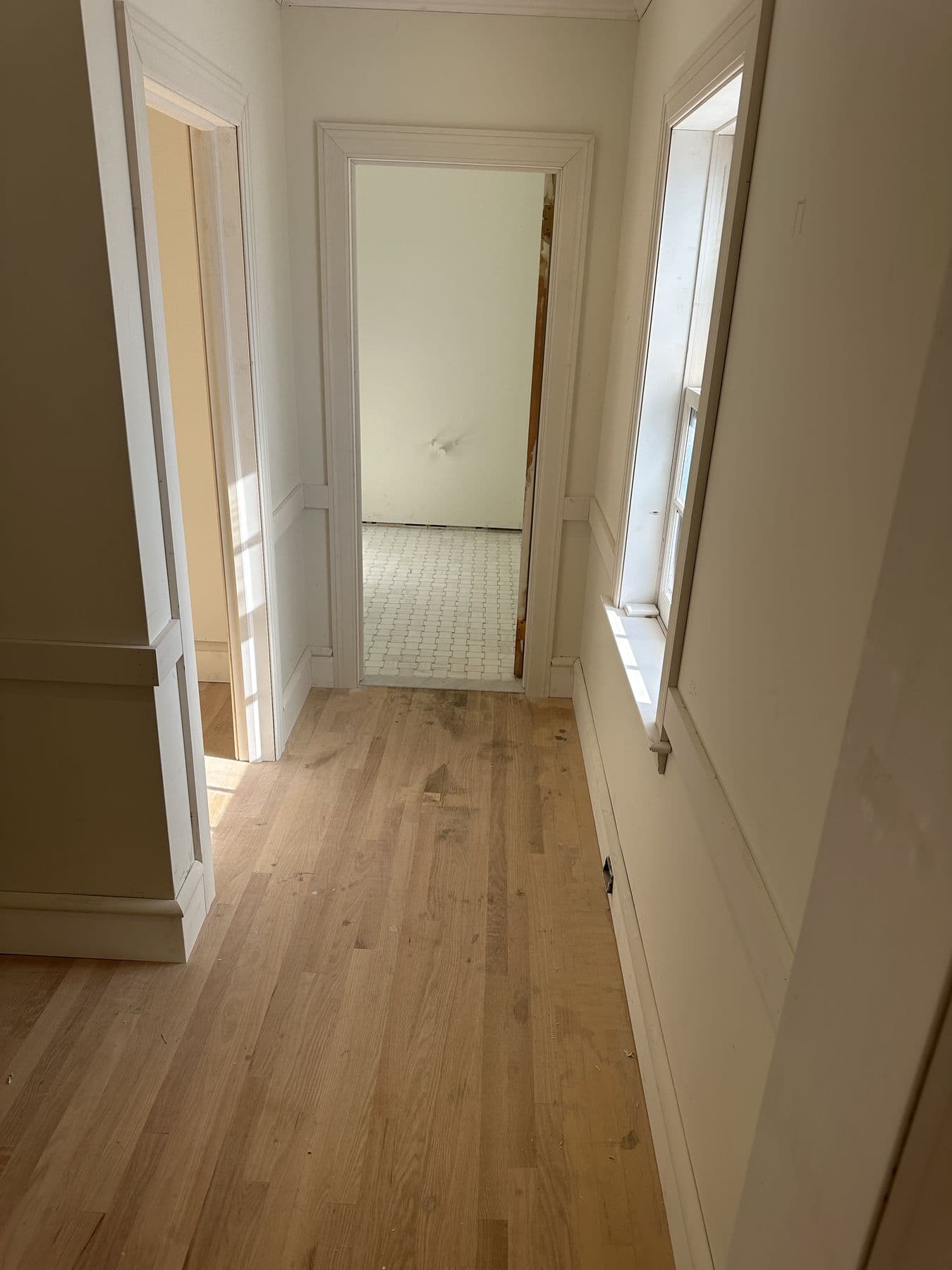 Narrow hallway with wainscot panels and new white oak flooring
