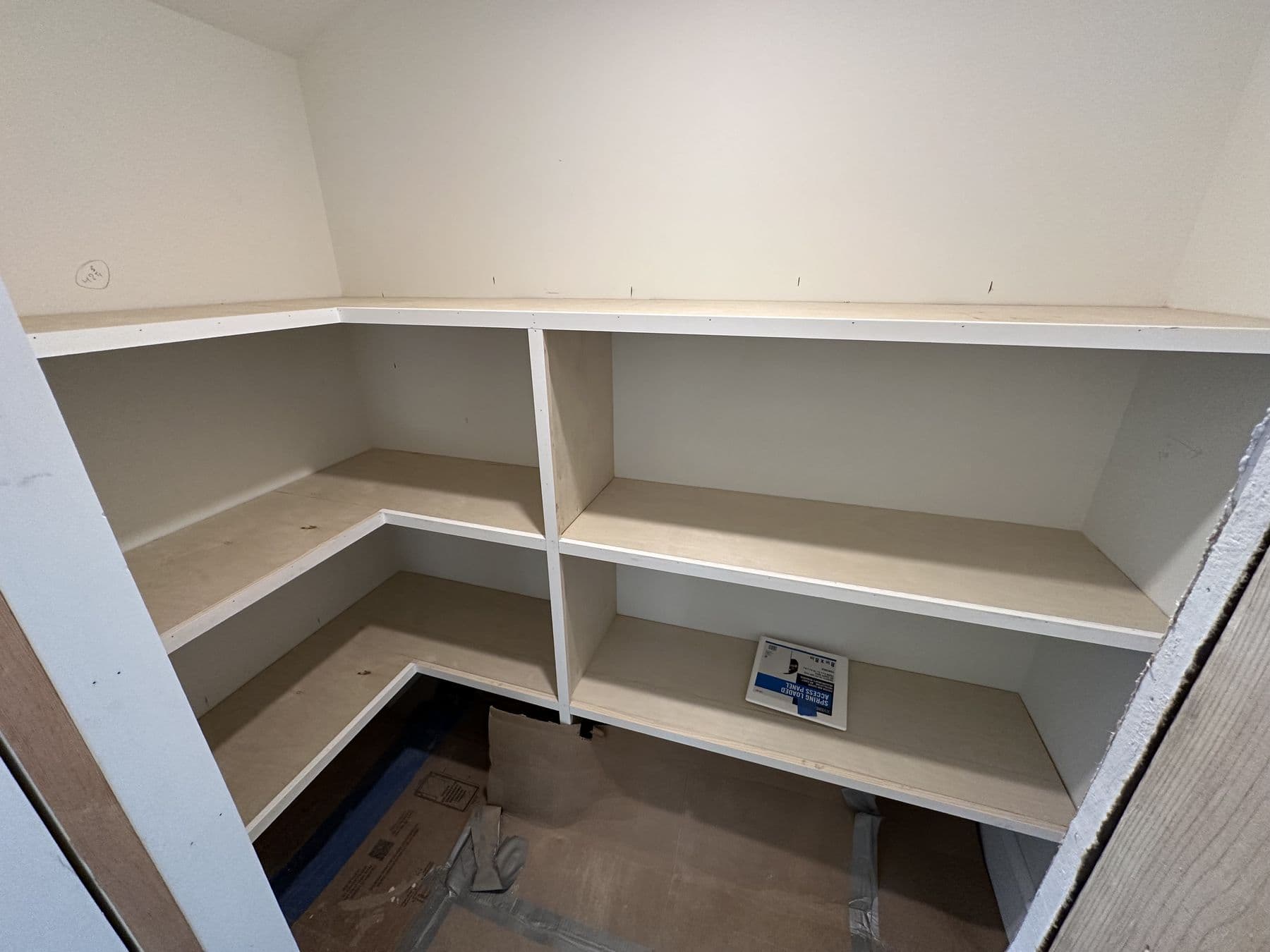 L-shaped built-in shelving in a closet under the roof slope