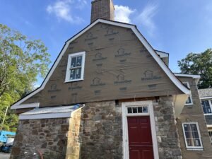 Benjamin Obdyke HydroGap drainable housewrap installed on a gambrel gable over fieldstone foundation during re-siding project in Kennett Square PA Chester County