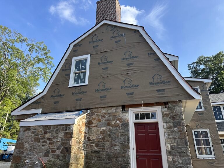 Benjamin Obdyke HydroGap drainable housewrap installed on a gambrel gable over fieldstone foundation during re-siding project in Kennett Square PA Chester County