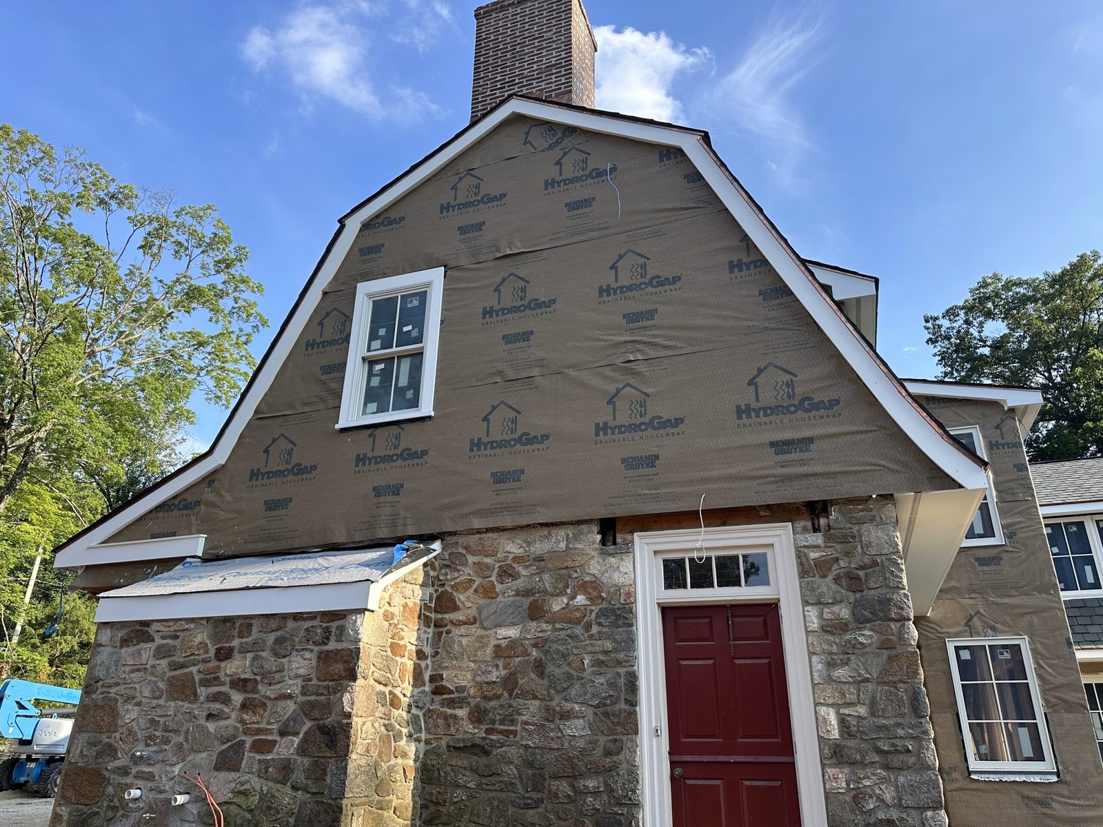 Benjamin Obdyke HydroGap drainable housewrap installed on a gambrel gable over fieldstone foundation during re-siding project in Kennett Square PA Chester County