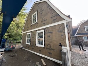 Gambrel home wrapped in HydroGap drainable housewrap with new windows before siding installation