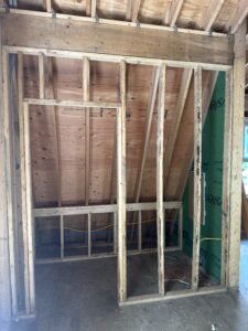 Interior wall and closet framing under a sloped roofline with ZIP System sheathing during construction